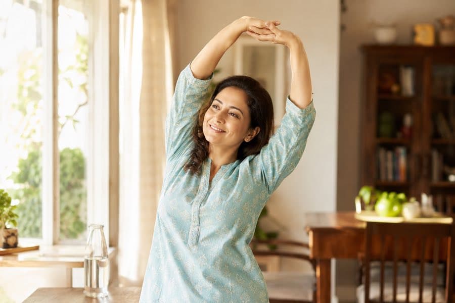 A person stretching as part of a morning wellness routine